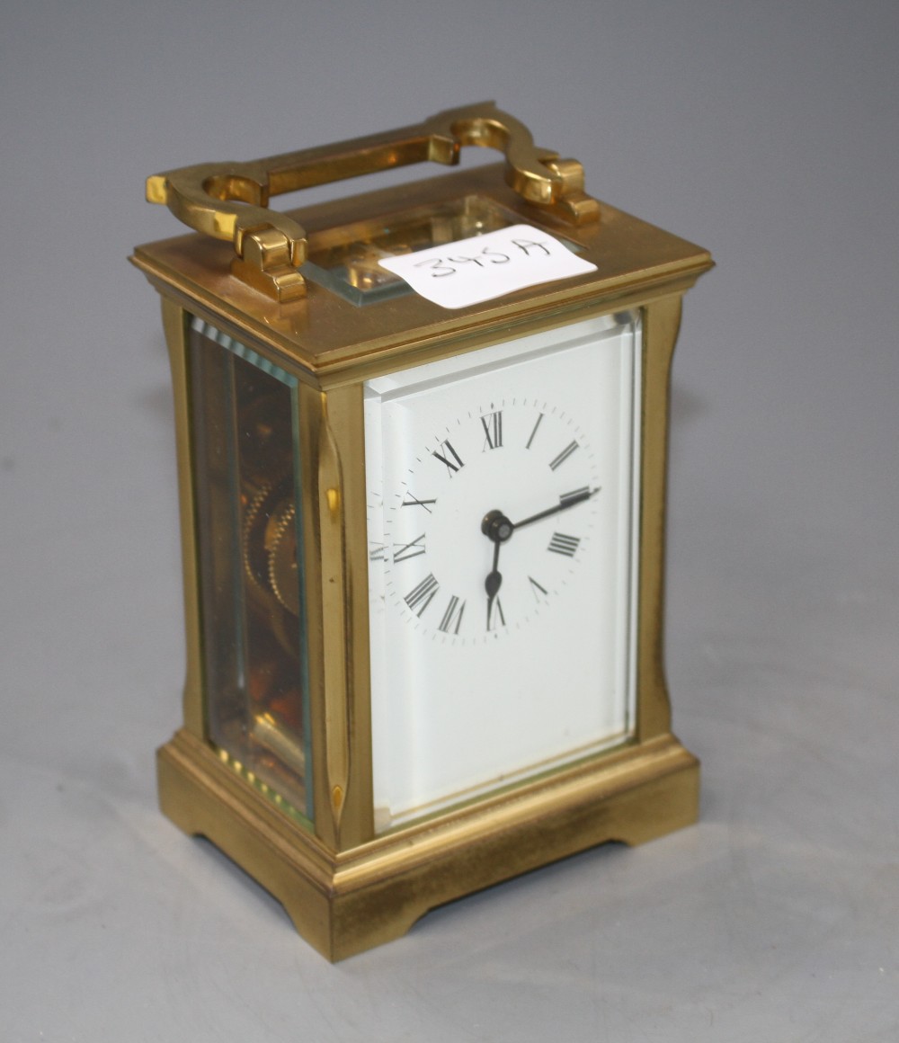 An Edwardian brass carriage timepiece with enamelled Roman dial, height 12.5cm